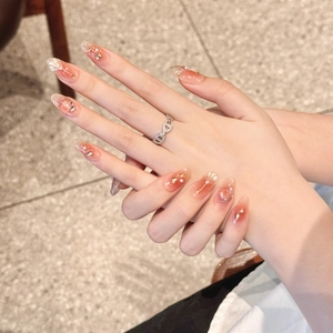 Handmade peach gradient press-on nails with pearls and sequins in almond shape