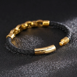 Close-up of black braided leather bracelet with a gold stainless steel magnetic clasp