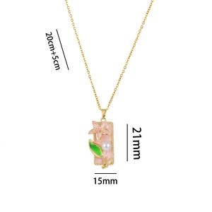 Elegant gold flower necklace with pink enamel and pearl pendant on white background
