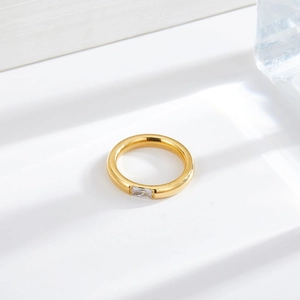 Minimalist gold plated stainless steel ring with a baguette cut clear zircon stone