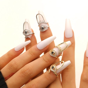 Evil eye nail rings set with zircon stones in gold and silver plating on fingertips