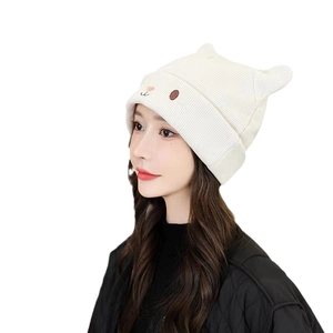 White knitted cat ear beanie for women featuring cute cartoon embroidery details
