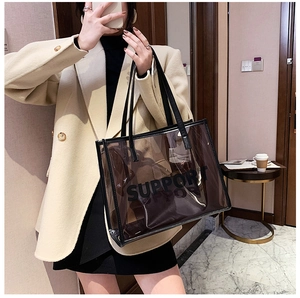 Transparent PVC tote bag with leather pouch shown in a mirror selfie for a casual chic style