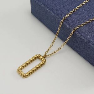 18K gold plated stainless steel twisted rectangle pendant necklace on jewelry box