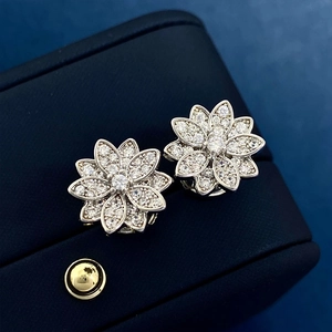 Elegant lotus flower stud earrings with sparkling crystals on dark blue jewelry box gift set