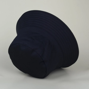 Close-up of the reinforced stitching and durable twill fabric on the navy blue bucket hat