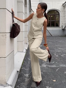 Elegant cream women vest and wide-leg trousers suit with metal buttons and draped cut