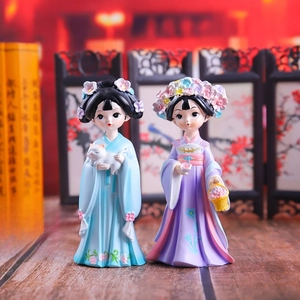 Detailed view of two resin figurines in traditional Hanfu holding a cat and flower basket
