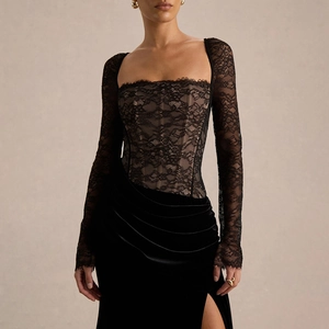 Detail of elegant black lace bodice and velvet high-slit evening dress for women