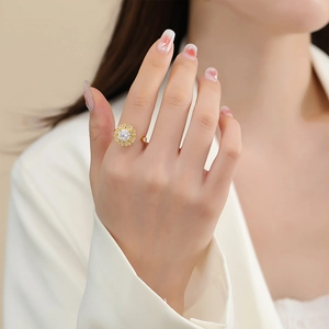 Detailed view of rotating gold flower ring with heart petals and sparkling cubic zirconia