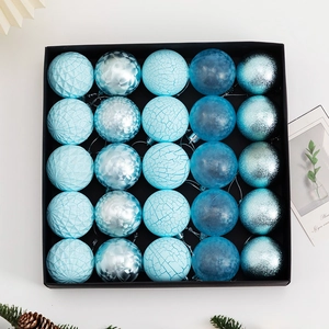 Detail of 25-piece blue Christmas ball set with textured finishes in a black gift box