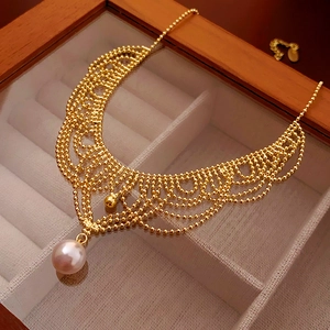 Detailed macro view of French vintage pearl necklace with intricate gold filigree craftsmanship