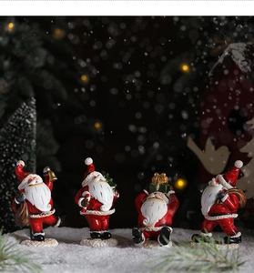 Detailed view of four miniature Santa figurines standing on snow in festive lighting