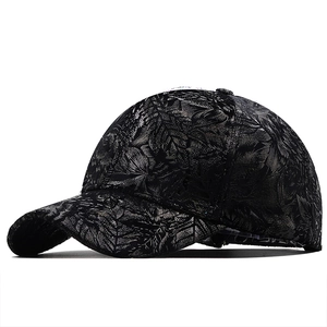 Detail shot of the textured jacquard leaf pattern and crown on a dark baseball cap