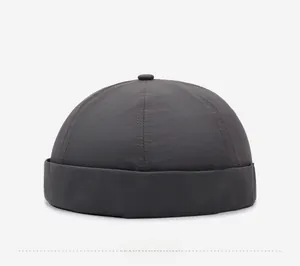 Side view of dark gray docker cap featuring six-panel construction and wide brim detail