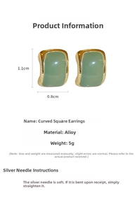 Detail view of gold-trimmed square stud earrings with green enamel and 1.1cm x 0.8cm size