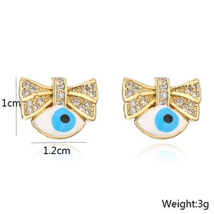 Detail view of 18K gold plated bowknot evil eye studs with measurements 1cm x 1.2cm