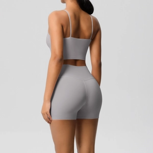 Back view of a grey-white yoga set with thin straps and high-waisted shorts