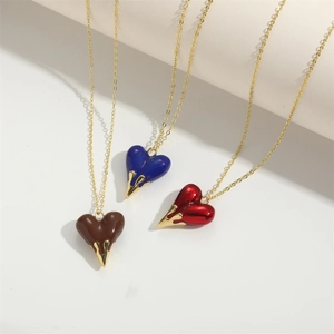 Classic love heart pendant necklaces in red, blue and brown with unique gold drip detail