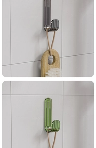 Strong adhesive transparent hooks in emerald and smoky grey on marble wall