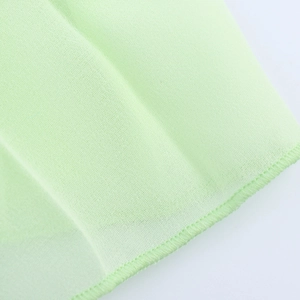 Close-up of light green satin texture with breathable mesh weave and fine edge stitching