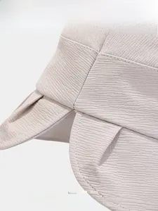 Detail of overlapping brim on cotton bucket hat showing fine twill fabric and color options