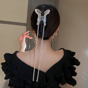Silver butterfly hair claw clip with rhinestones and long tassel on model back