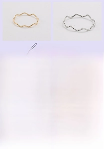 Detail view of wavy titanium steel rings with 18K gold vacuum plating finish