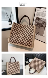 Detail view of khaki checkered tote bag made of high-quality canvas on a desk