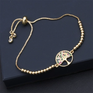 Macro detail of adjustable gold tree of life bracelet with colorful zircon stones