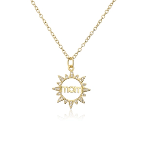 Detail of 18K gold-plated sunburst pendant with mom cutout and sparkling zircons