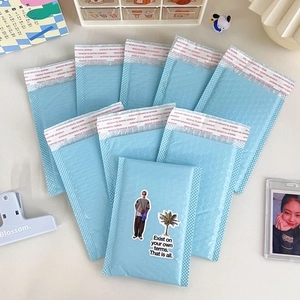 Close-up of light blue padded bubble mailer with self-adhesive seal and matte finish