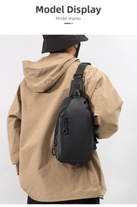 Men's black crossbody chest bag with waterproof fabric and adjustable strap shown on model