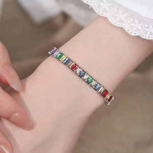Rainbow cubic zirconia tennis bracelet with multi-color rectangular gemstones on wrist