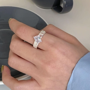 Detail of 925 silver ring with large square zircon and unique Cuban chain design band
