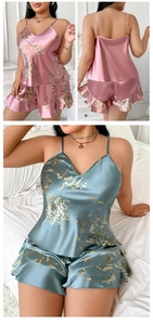 Detail view of satin floral pajamas featuring V-neck camisole and ruffled hem shorts