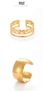 Detail view of gold adjustable cuff bracelet with hammered texture and leaf patterns