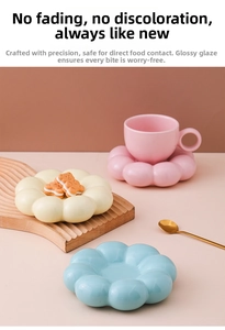 Detailed view of pink ceramic sunflower macaron coffee cup on a petal-shaped coaster