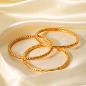 Three-piece gold stainless steel bangles set with hammered and twisted rope textures