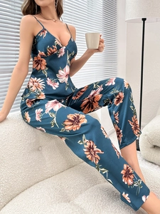 Detail of floral printed satin sleepwear showing smooth texture and v-neck strap top