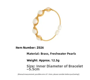 Detailed macro view of 18k gold plated brass wire-wrapped bracelet with freshwater pearls
