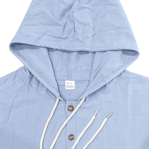Detail view of light blue linen blend hoodie collar, buttons, and fabric texture
