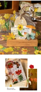 Close-up of vintage flower stickers and butterfly cards on a wooden stand holder