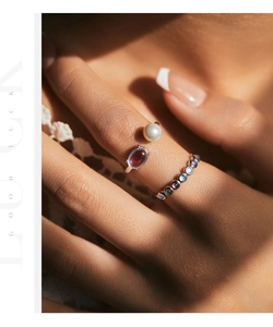 Detail of silver S925 moonstone ring with pearl and colorful gemstone stacking bands