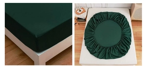 Detailed view of dark green fitted sheet with elastic edges and close-up fabric texture