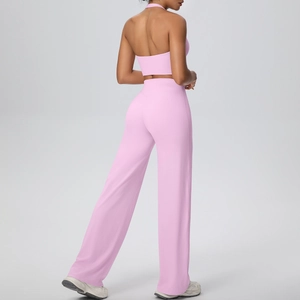 Rear view of pink halter neck sports top and high waisted wide leg pants gym set