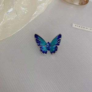 Detail of blue gradient butterfly brooch with rhinestone inlay and silver-toned metal base