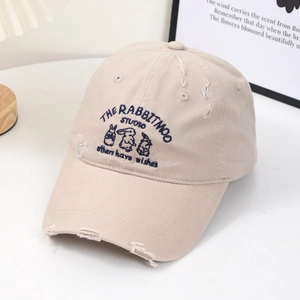 Distressed beige baseball cap with rabbit embroidery and wide brim for a slim facial look