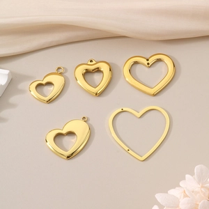 Detailed view of five assorted polished gold hollow heart pendants for DIY jewelry
