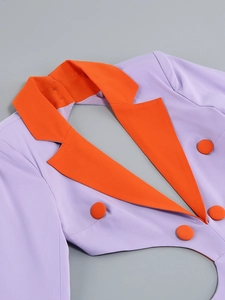 Detail of color-block blazer featuring orange lapels and matching buttons on purple fabric